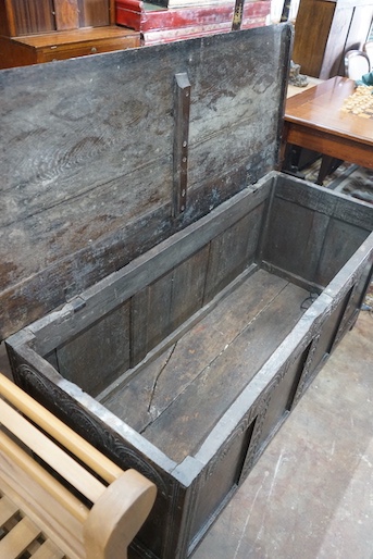 An 18th century and later carved panelled oak coffer, width 145cm, depth 58cm, height 61cm